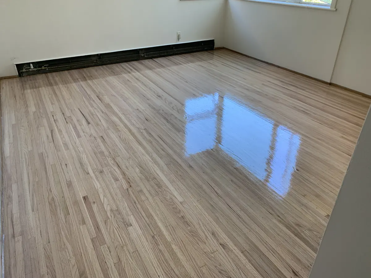 Refinished hardwood in an empty apartment suite