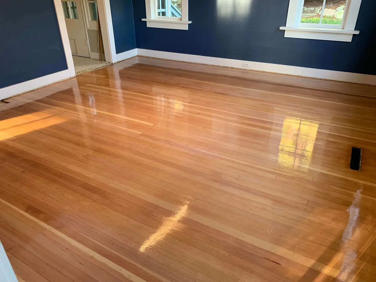 The same floor refinished with an even, warm tone