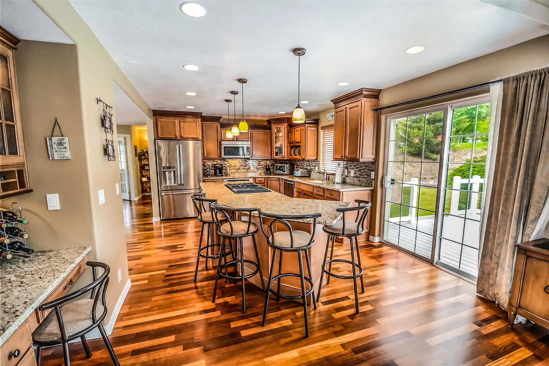 Refinished golden oak flooring running through an open-plan kitchen