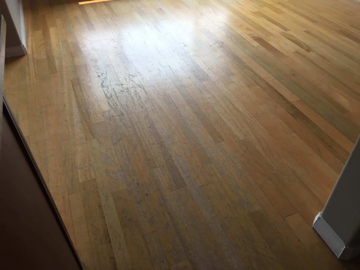Scuffed living room floor with a dulled finish